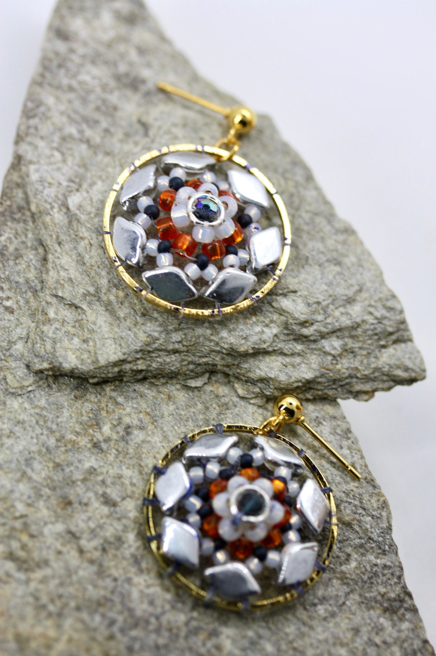 Orange and navy blue intricate beadwork small circular dangle earrings
