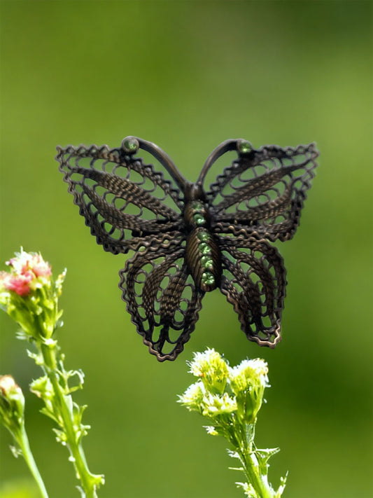 Detailed vintage filigree butterfly pin with tiny emerald green rhinestones