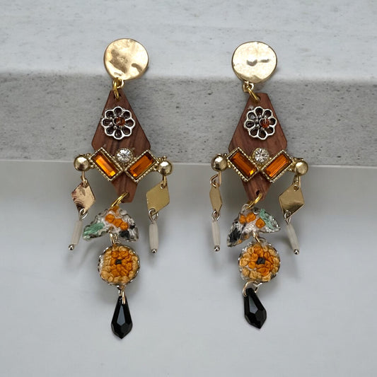 Mixed media earrings made with embroidery from a vintage linen table runner, rosary wood, hammered metal, glass tubes, orange rhinestones