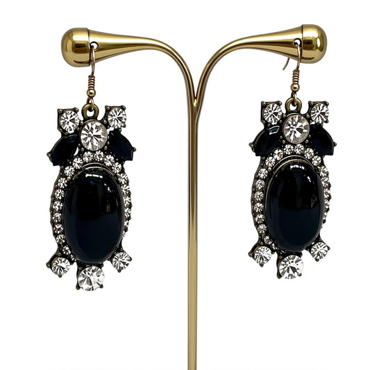 A pair of elegant earrings with black stones and sparkling rhinestones.