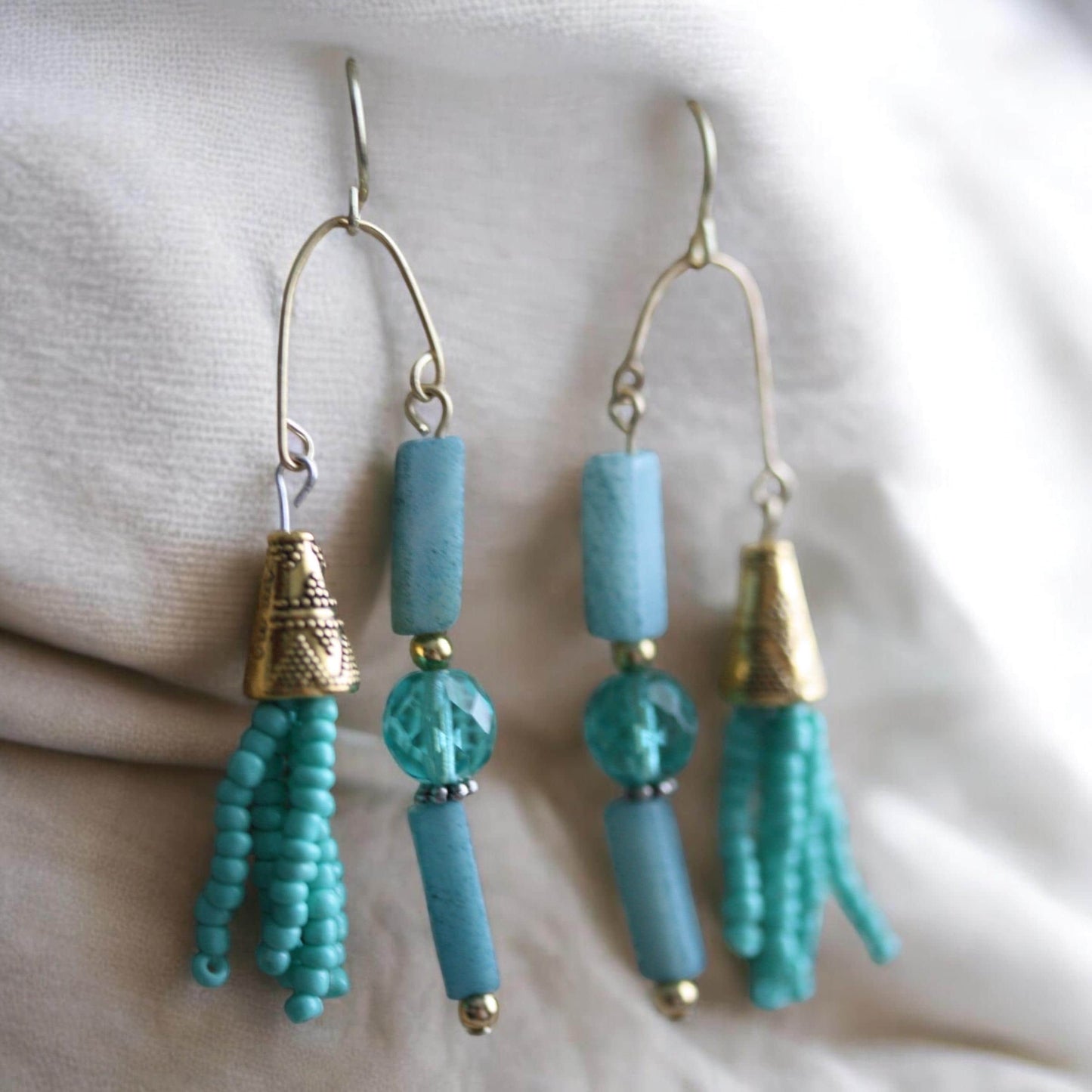 Asymmetrical mixed material turquoise crystal, stone and seed beads with goldtone trim - 2 and one-half" long earrings
