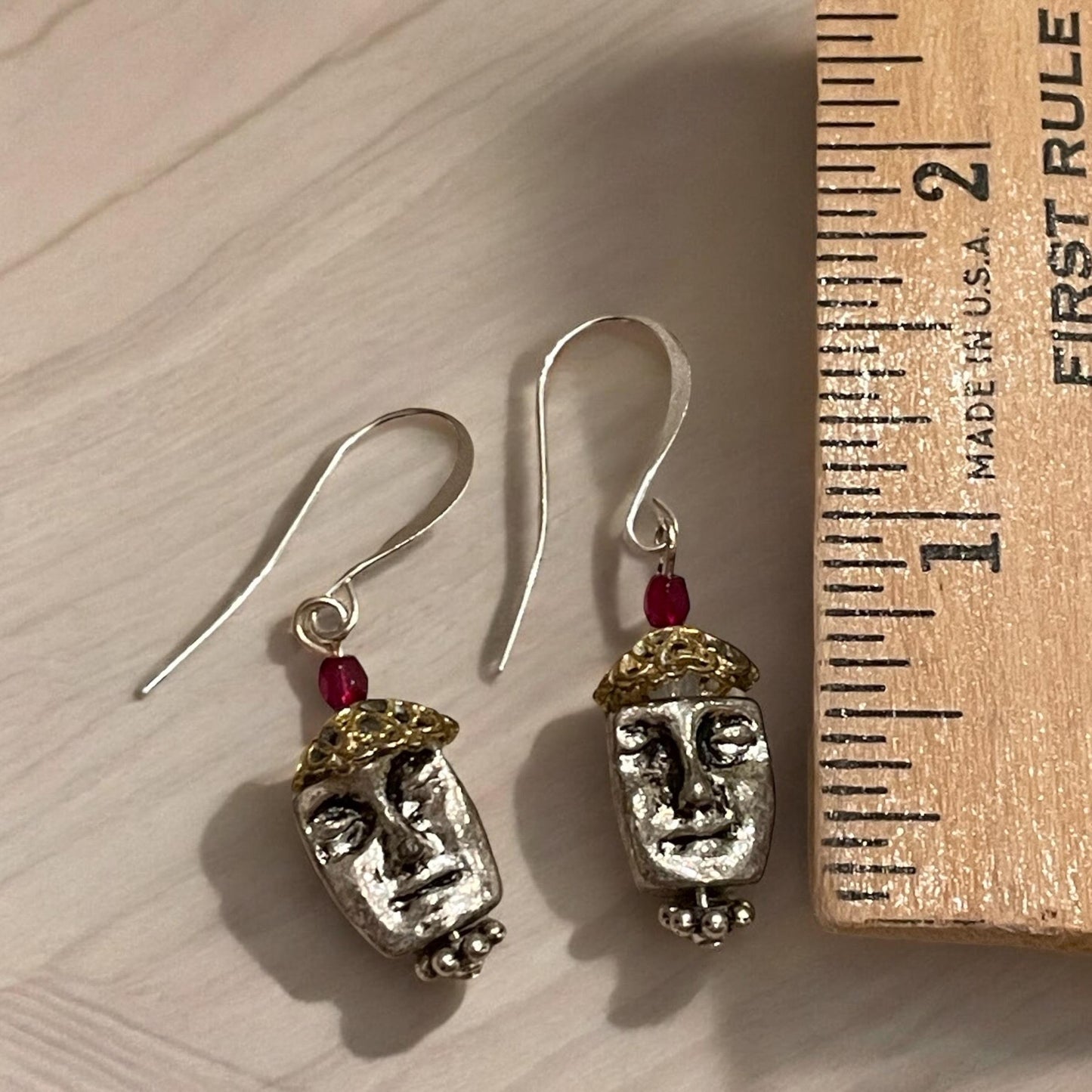 Unique silver tone face earrings with mixed metal and red crystals