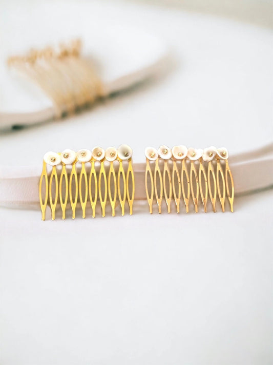 Pair of ivory white shell hair combs with goldtone centers