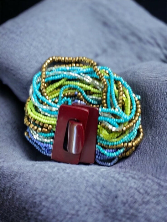Stunning vintage bracelet - loaded with dozens of strands of tiny glass beads - plastic or bakelite closure?