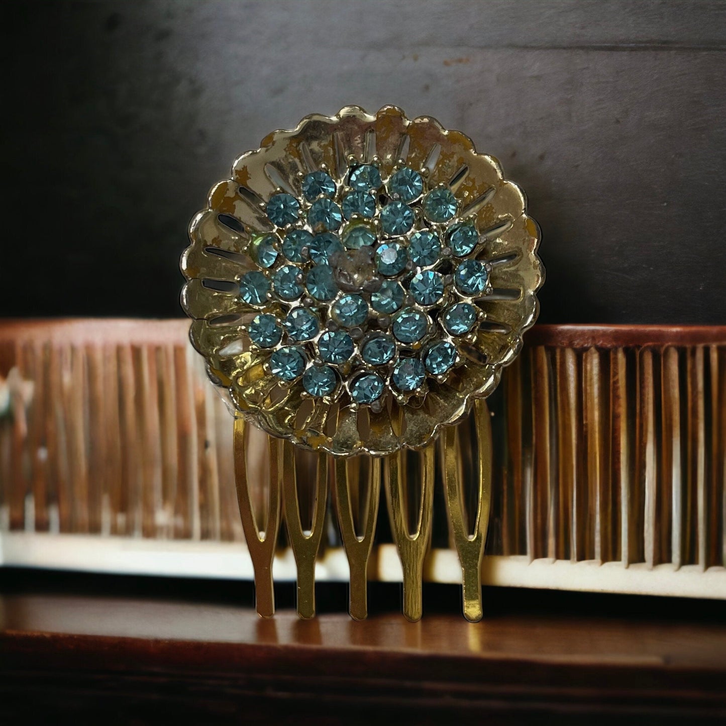 Hair comb featuring a stunning baby blue rhinestone studded vintage goldtone flower