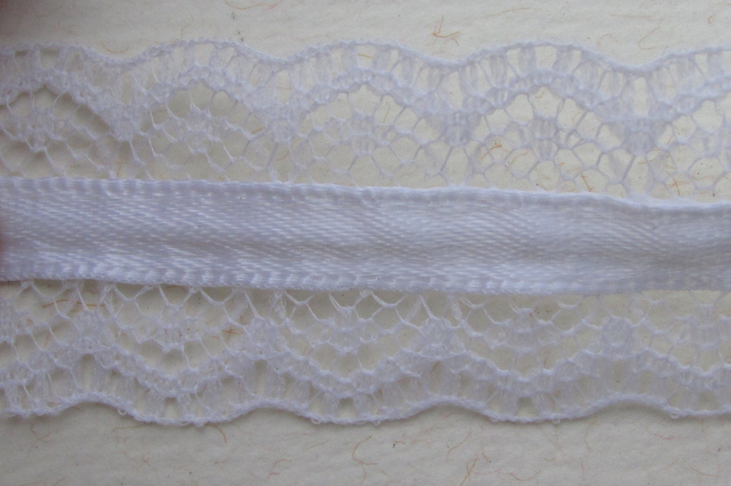 Victorian-style vintage narrow white lace with white ribbon in the center - by the yard