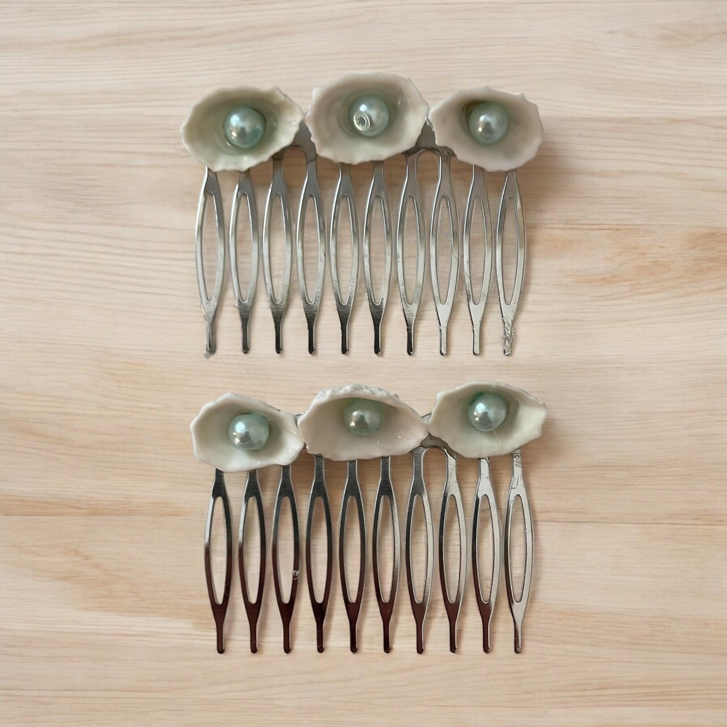 Pair of Hair combs made of white shells with light blue pearl centers