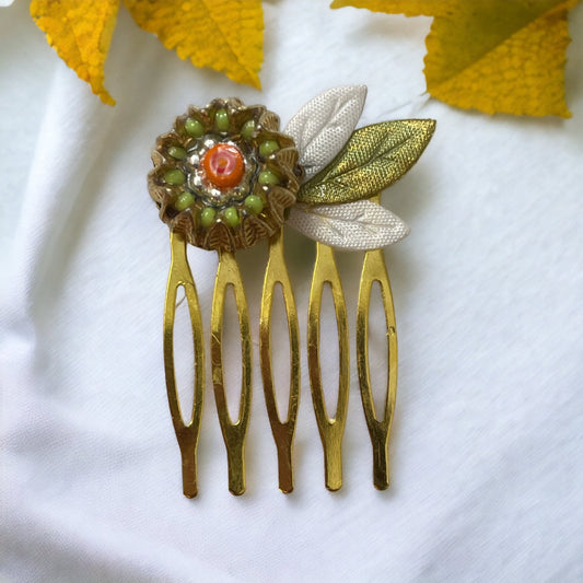 Small 1" hair comb featuring beaded mixed medium upcycled metal floral crown trimmed with satin green and white leaves.