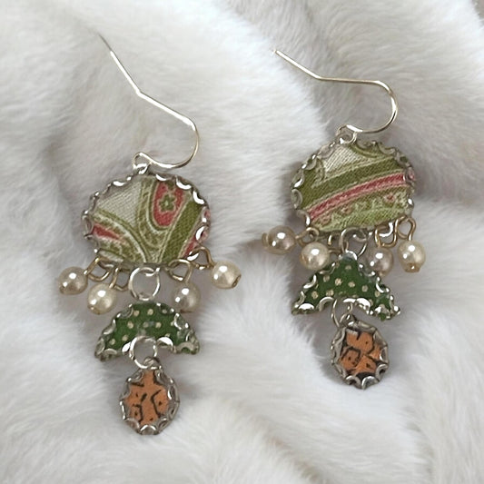 Handmade earrings featuring green and white polka dot fabric with peach and cream paisley and dangling faux pearls. Sterling ear wires.