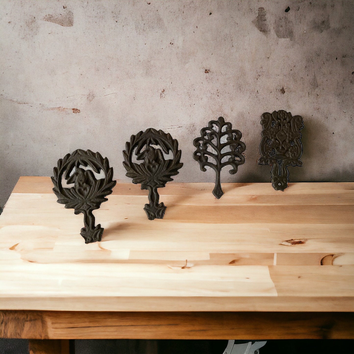 Set of 4 small cast iron trivets - vintage or antique?