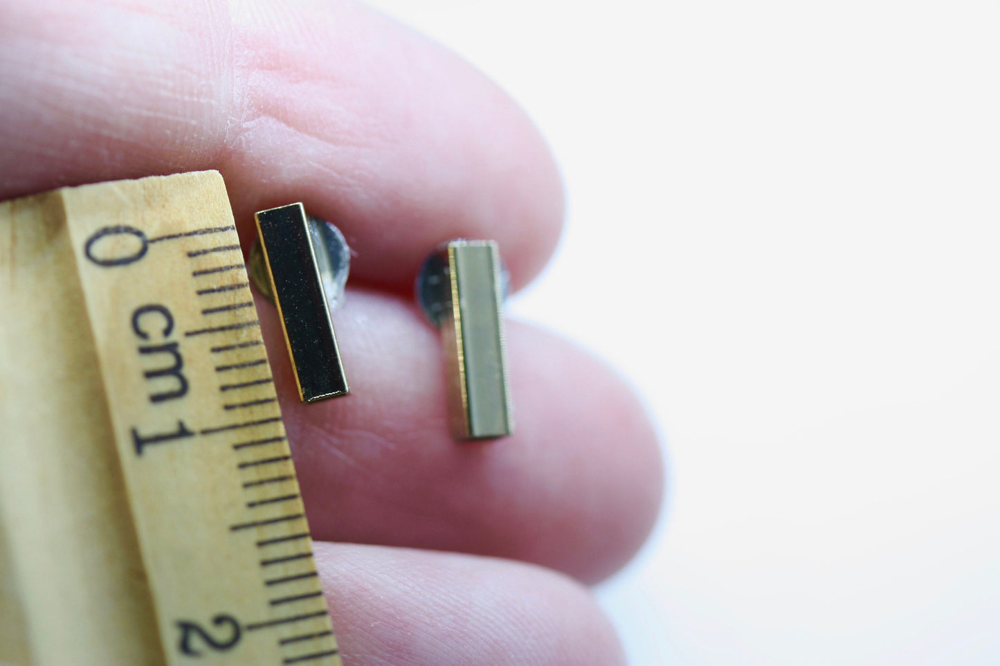 Tiny barely-there goldtone bar on silvertone circle minimalist stud earrings