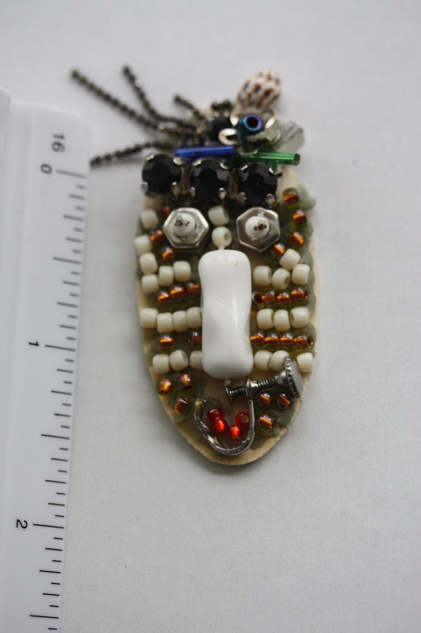 Meet "Sabina." Sabina is a really cool assemblage art gal who can be transformed into a necklace, pin or magnet