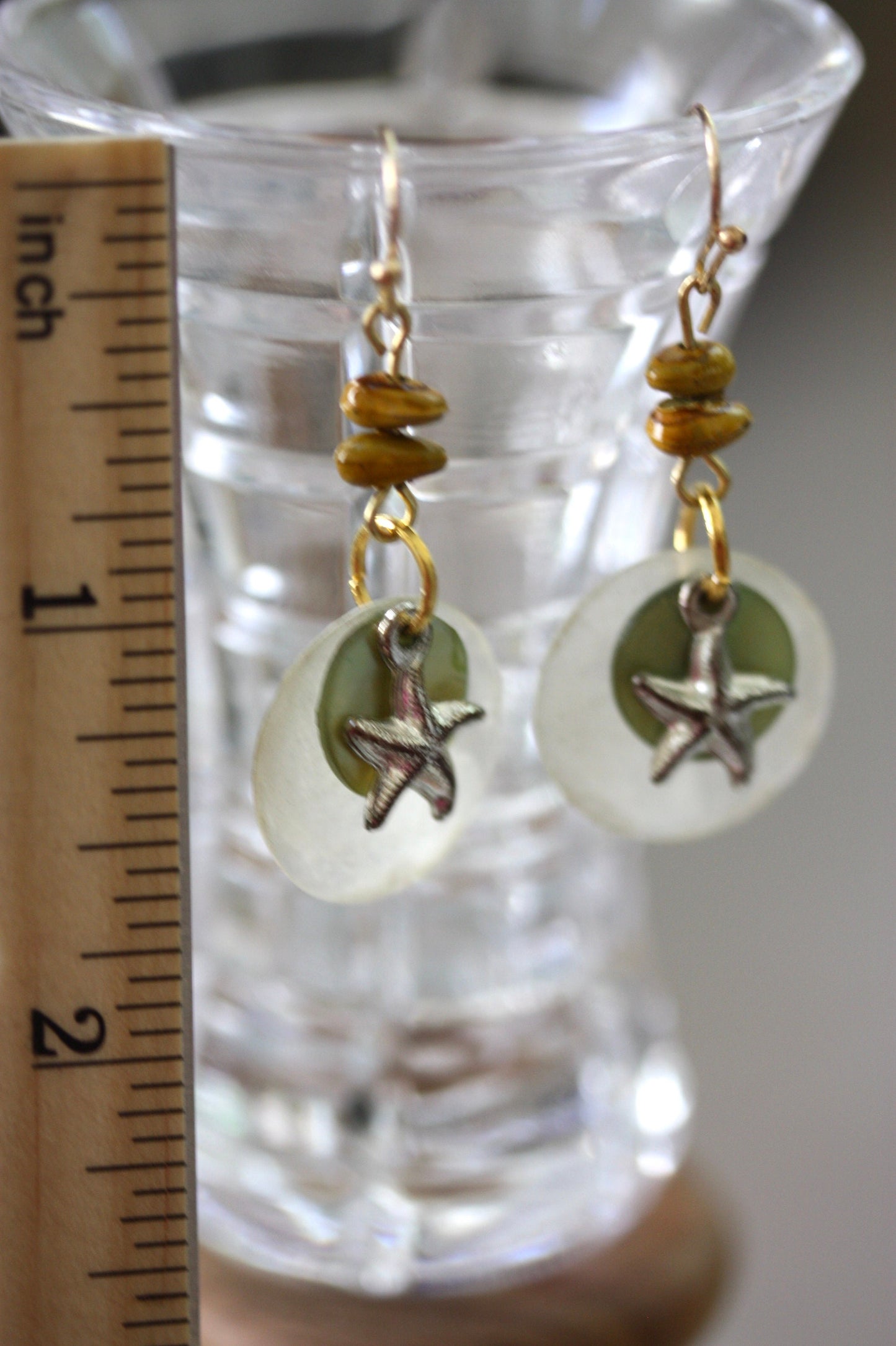 Mixed materials - green mother of pearl, metal starfish and yellow wood - beach themed dangle earrings