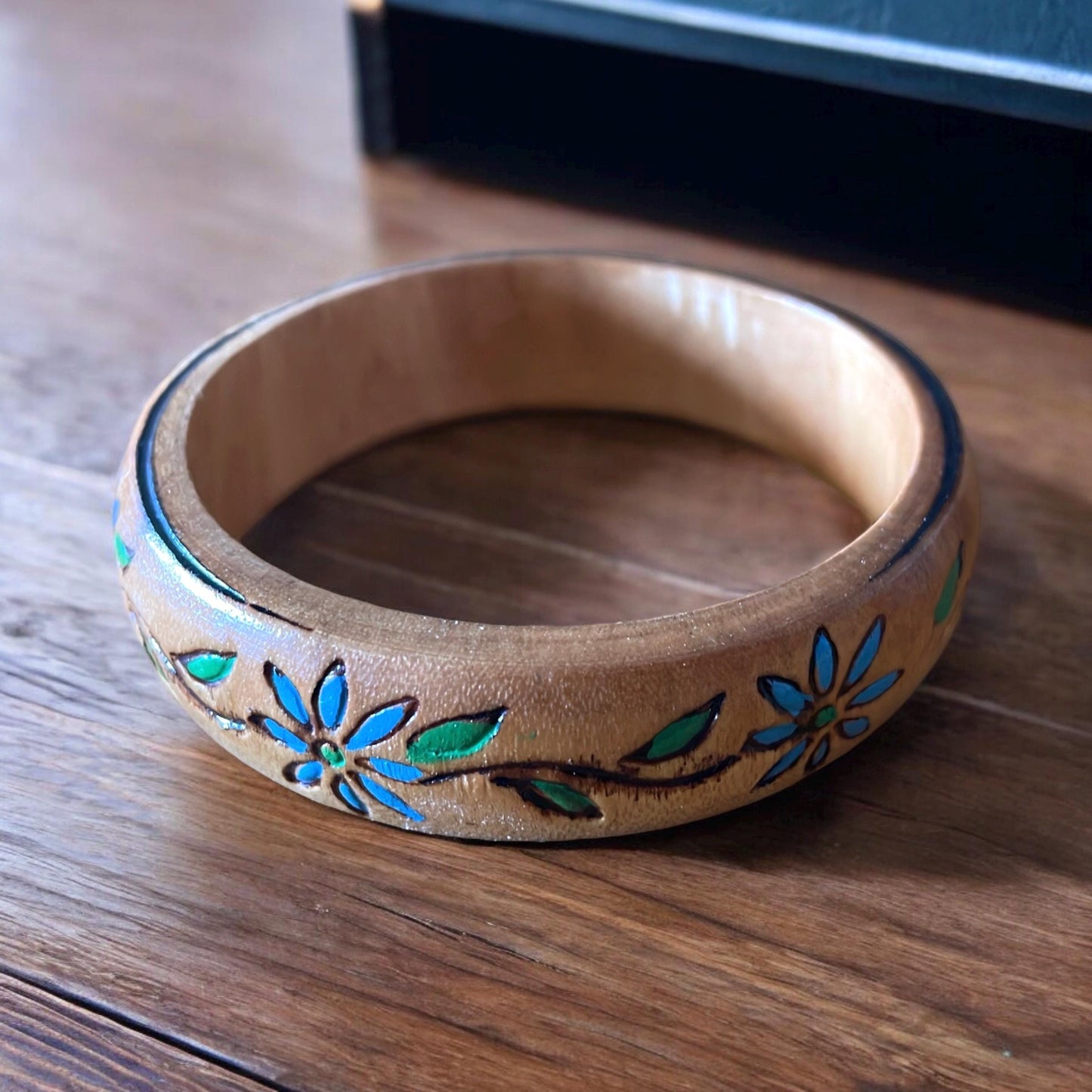 Carved wooden vintage bangle bracelet with blue flowers and green leaves