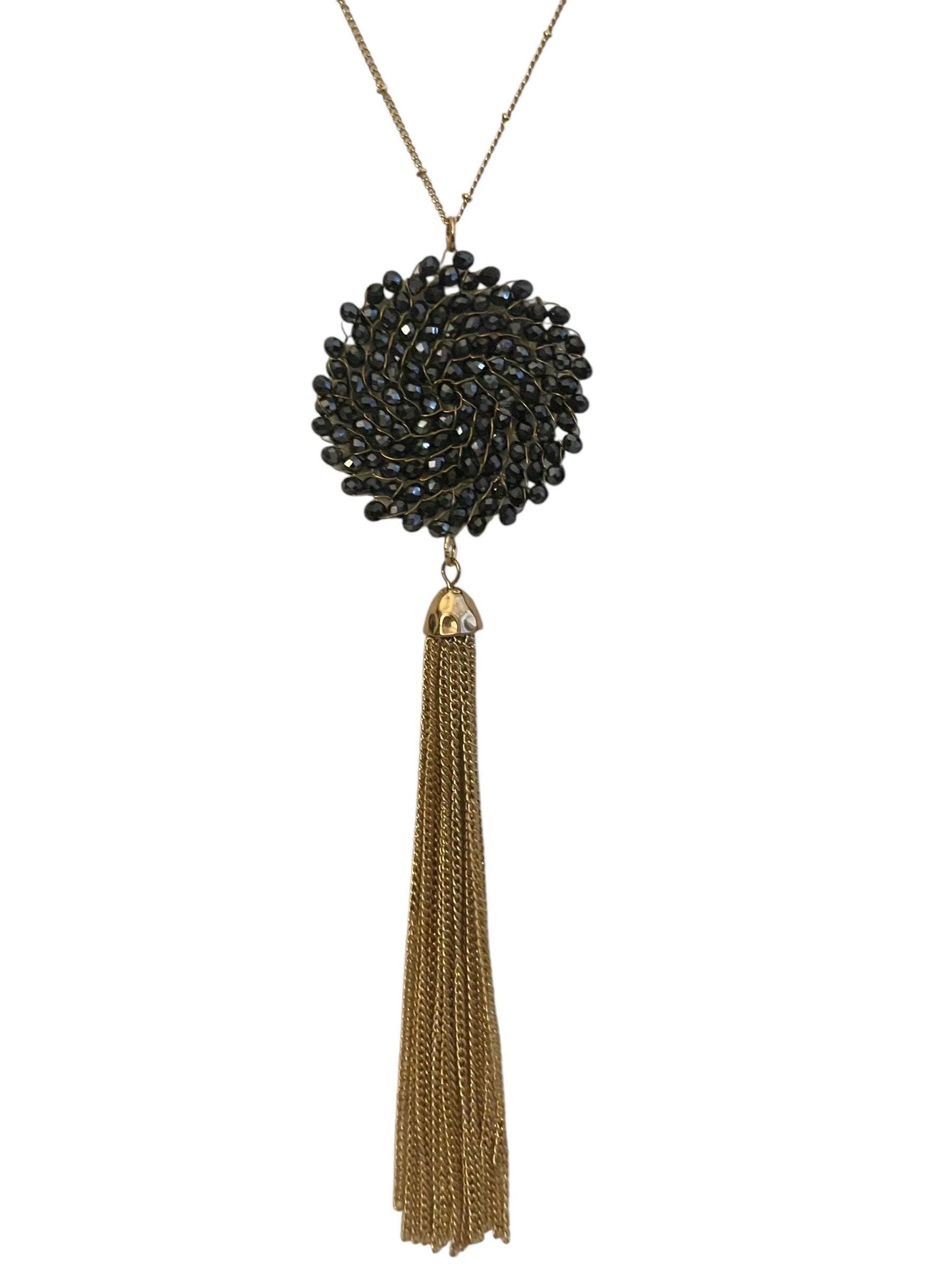Vintage necklace featuring a black crystal wire linked circular pendant with long goldtone tassel