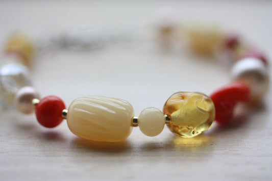 Handmade beaded bracelet featuring uniquely twisted orange vintage glass, amber colored crystal, pink pearls and etched striped beads - 7"