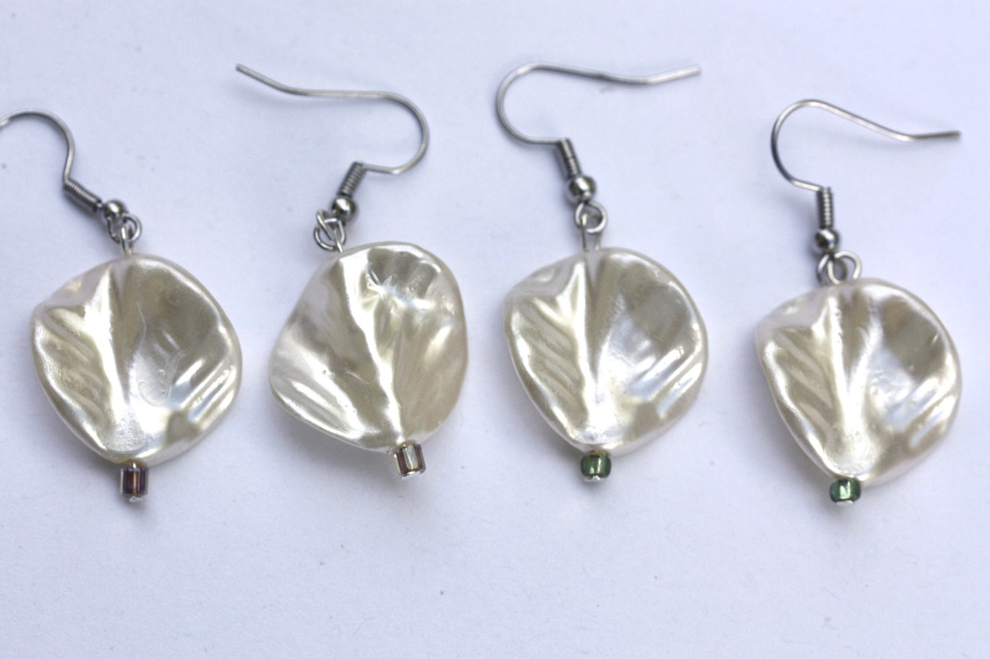 Pearlescent leaves dangle earrings trimmed with tiny sparkly seed beads