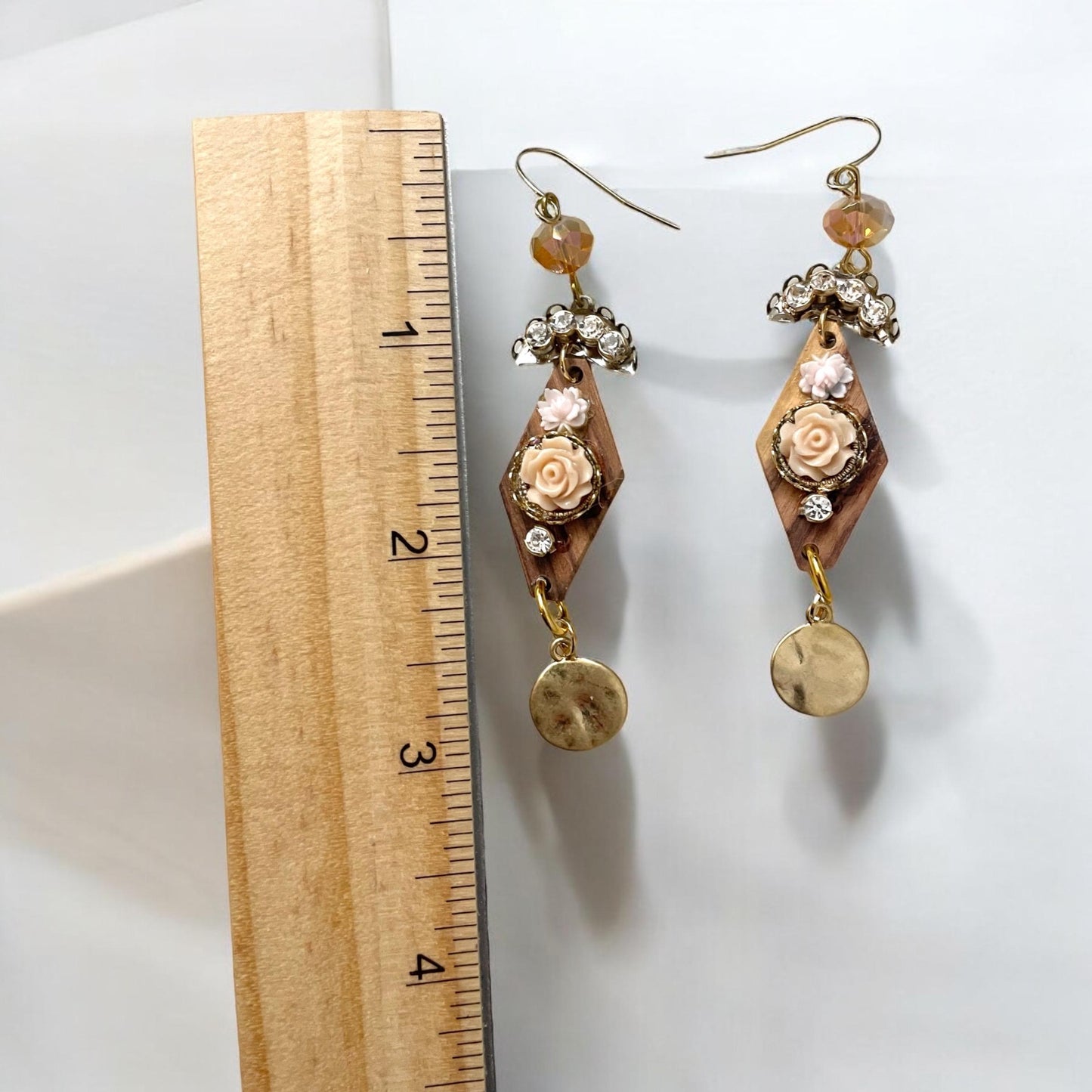 Dangle earrings with wood diamonds from a broken vintage rosary, etched roses, rhinestone, crystals and hammered discs. Sterling ear wires.