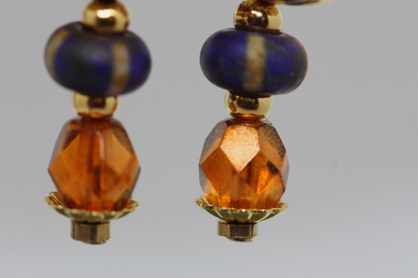 Burnt orange beaded earrings - paper covered beads, purple with cream stripes, orange fire polished crystals