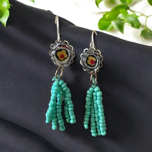 Handmade mixed media earrings featuring beaded turquoise tassel combined with vintage fabric snippets. Sterling silver ear wire.