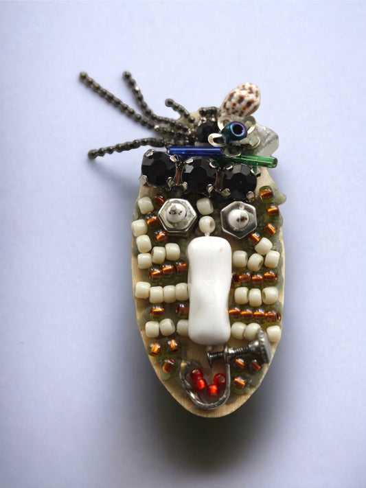 Meet "Sabina." Sabina is a really cool assemblage art gal who can be transformed into a necklace, pin or magnet