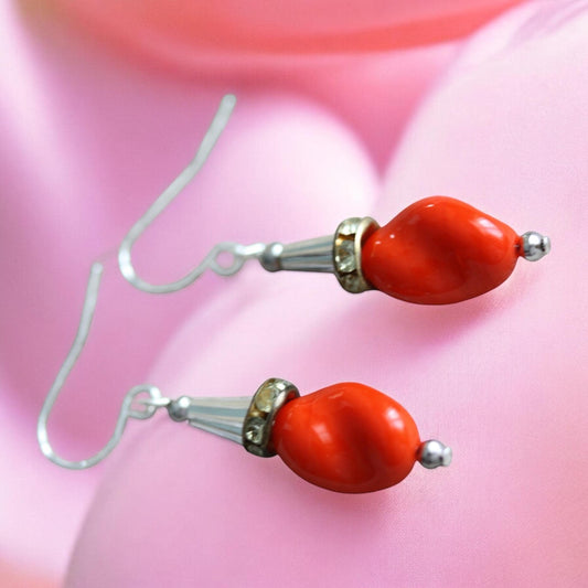 Unique dangle earrings featuring orange free form slightly twisted vintage glass, metal cone beads and rhinestone spacers