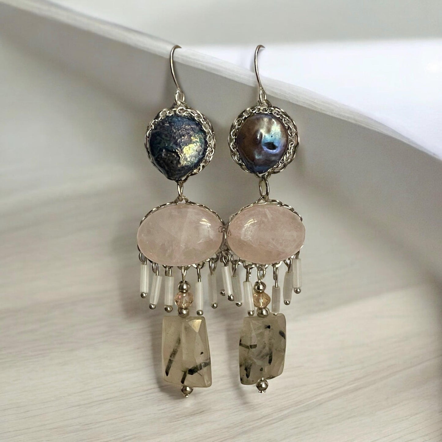 One-of-a-kind dangle earrings made with gray cultured pearls, rose quartz, Rutilated Quartz and white tube glass dangles. Sterling ear wires