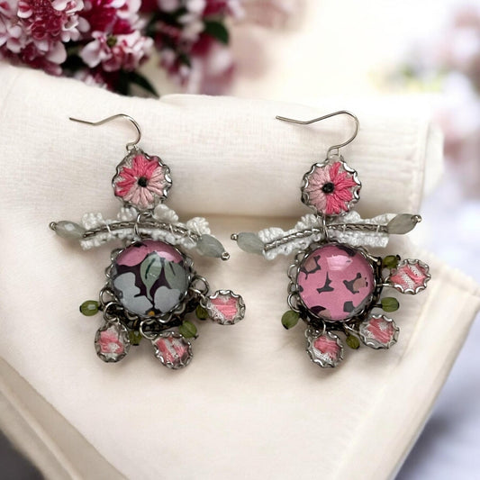 Mixed media earrings made with vintage crochet lace, embroidery from a vintage linen table runner, paper, satiny ribbon and mixed metals