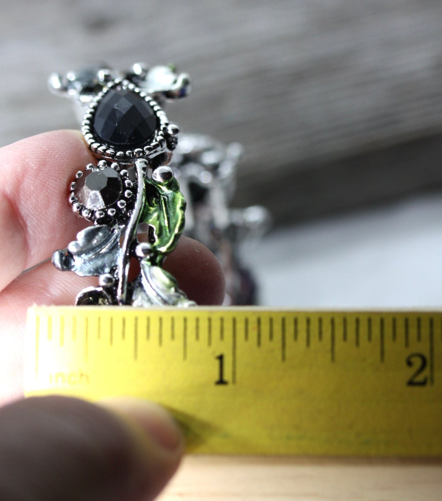 Stunning vintage costume jewelry cuff bracelet with black stones on silver with green leaves