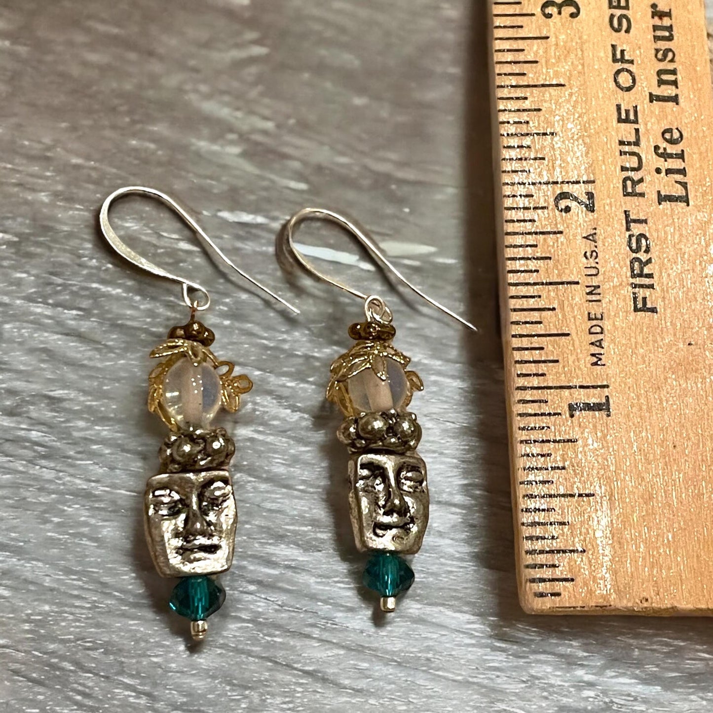 Unique silver tone face earrings with mixed metal and blue crystals