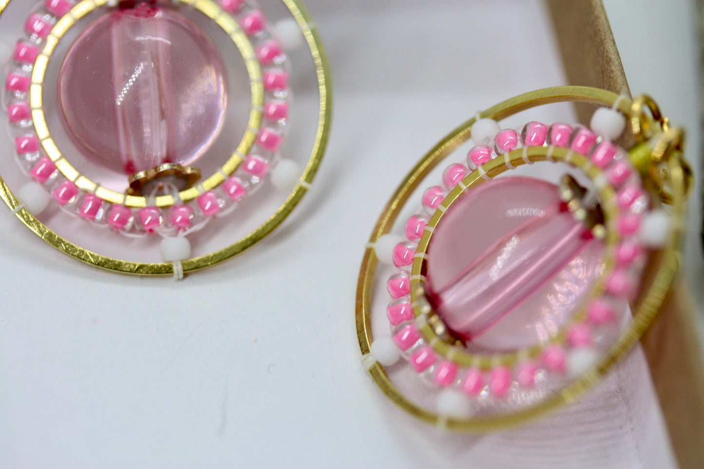 Pink and white intricate beadwork small circular dangle earrings