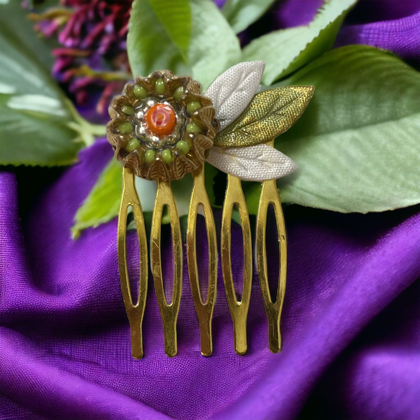 Small 1" hair comb featuring beaded mixed medium upcycled metal floral crown trimmed with satin green and white leaves.