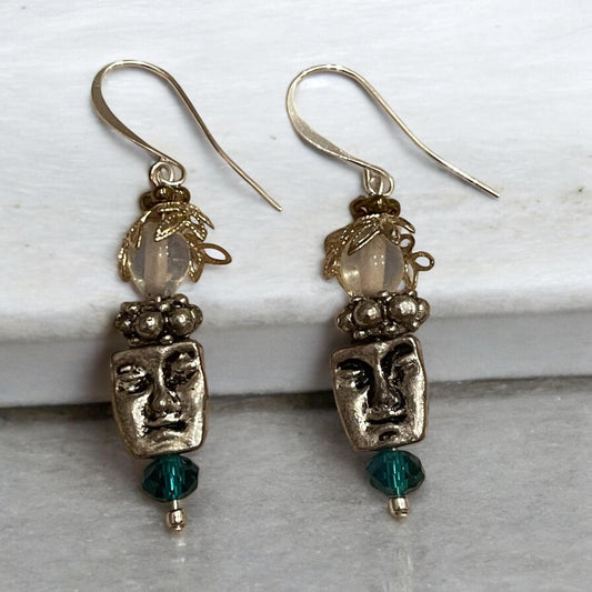 Unique silver tone face earrings with mixed metal and blue crystals