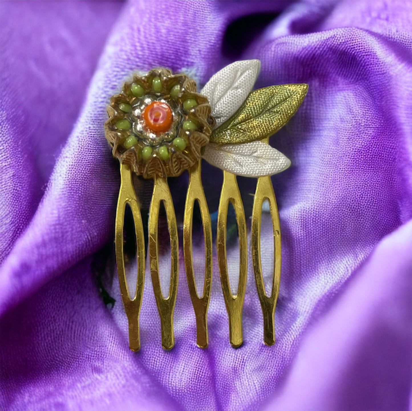 Small 1" hair comb featuring beaded mixed medium upcycled metal floral crown trimmed with satin green and white leaves.