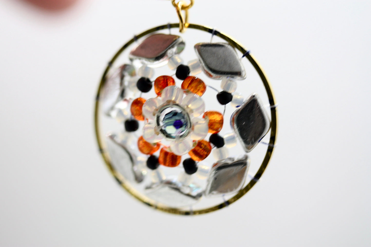 Orange and navy blue intricate beadwork small circular dangle earrings