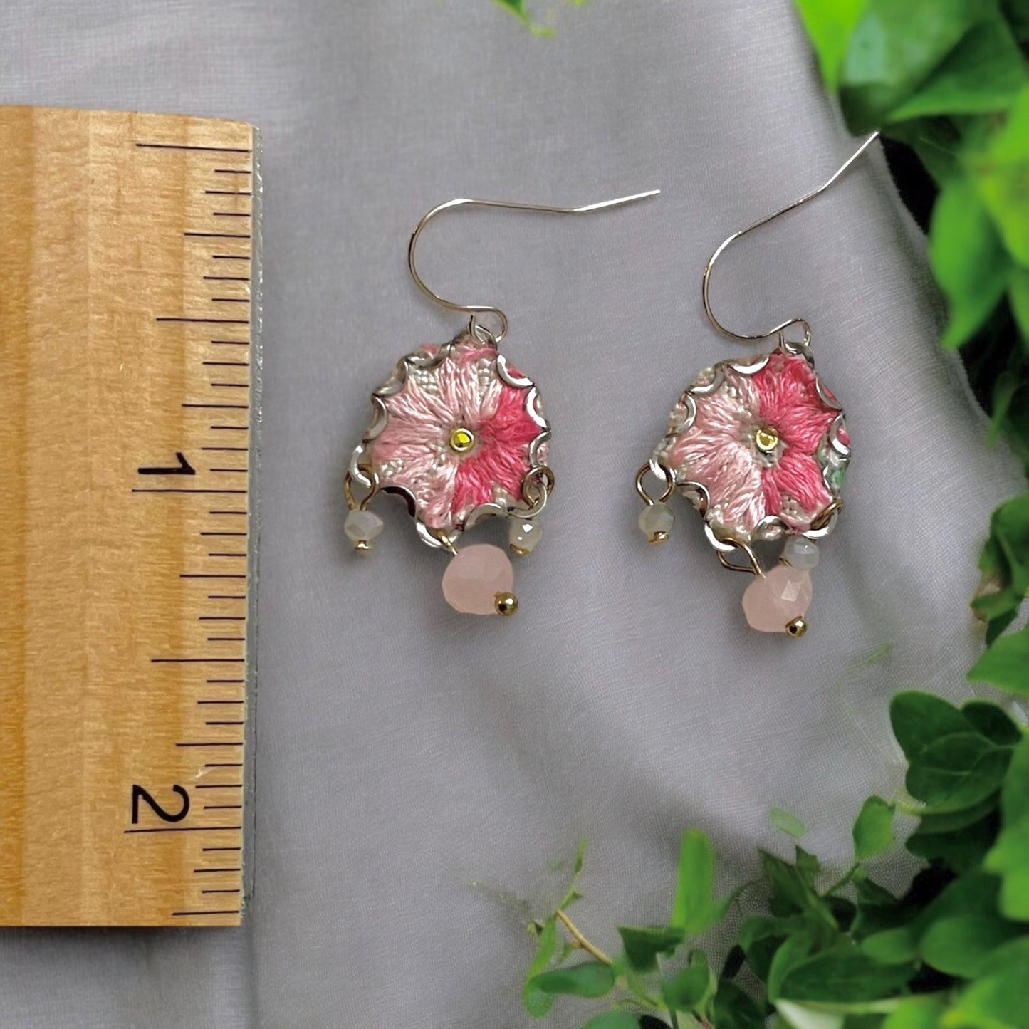 Handmade shades of pink mixed media earrings made with embroidery from a vintage linen table runner, combined with tiny dangles