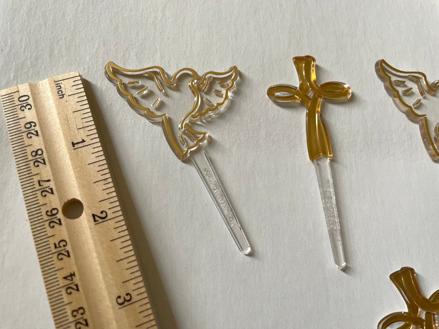 Mix of clear and gold plastic cake toppers - cross, fish and dove