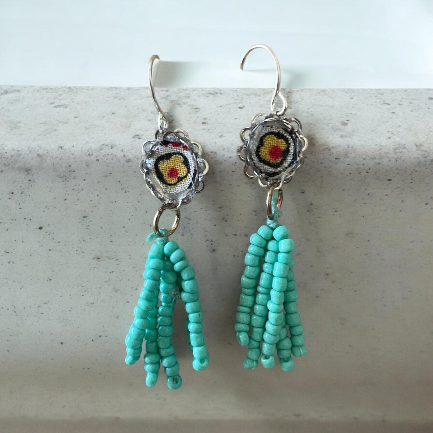 Handmade mixed media earrings featuring beaded turquoise tassel combined with vintage fabric snippets.  Sterling silver ear wire.