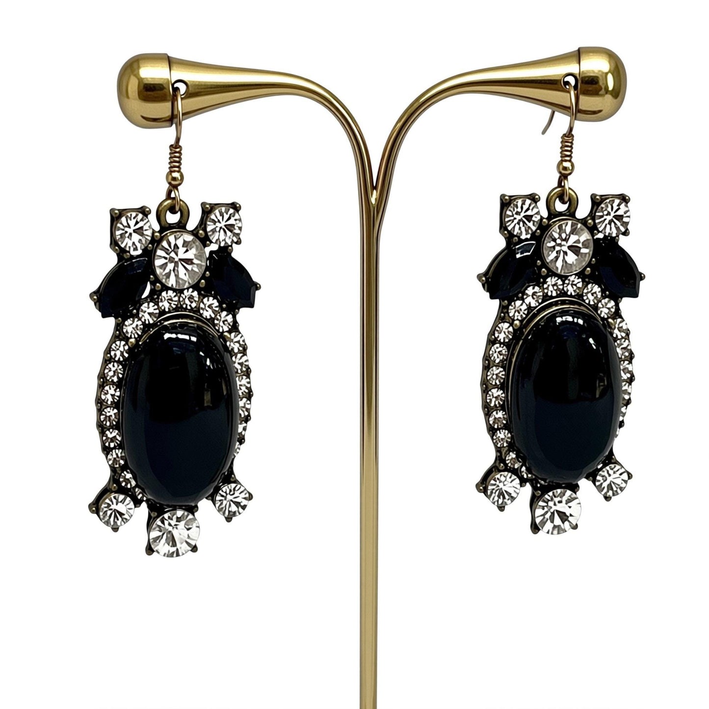 A pair of elegant earrings with black stones and sparkling rhinestones.