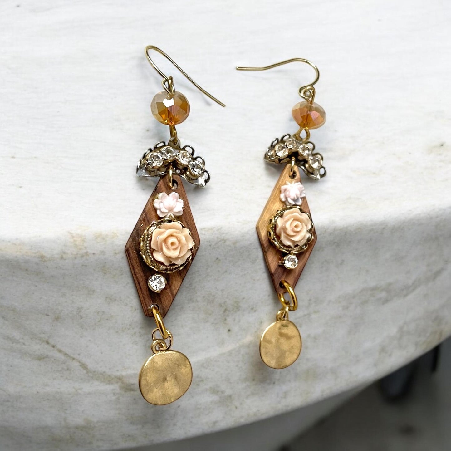 Dangle earrings with wood diamonds from a broken vintage rosary, etched roses, rhinestone, crystals and hammered discs. Sterling ear wires.