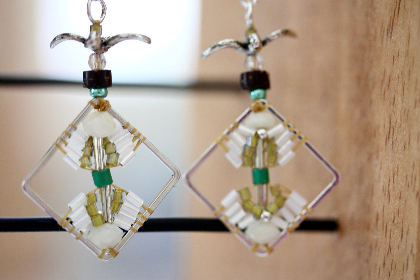Birds taking flight - intricate beadwork seed bead dangle earrings on diamond-shaped base with flying bird embellishments