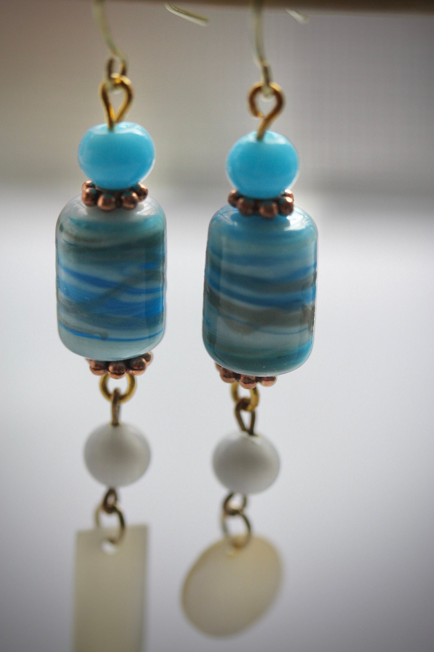 Long dangle earrings made of both new and vintage components -blue and gold art glass, mother of pearl dangles,vintage blue and white beads