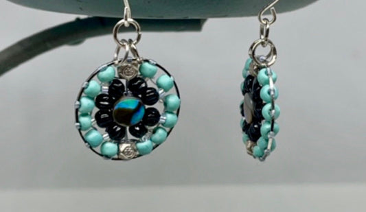 Small dangling handmade turquoise and black beadwork earrings with abalone centers