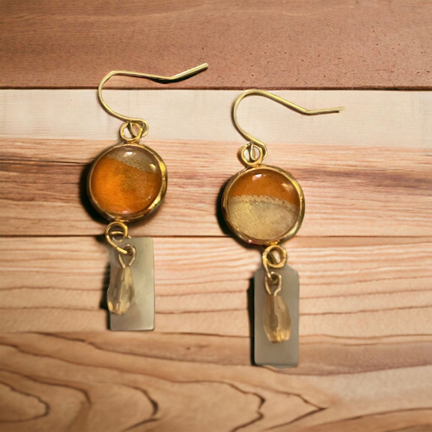 Orange and cream fabric inlaid glass cabochon earrings with rectangular mother of pearl and pale orange dangles