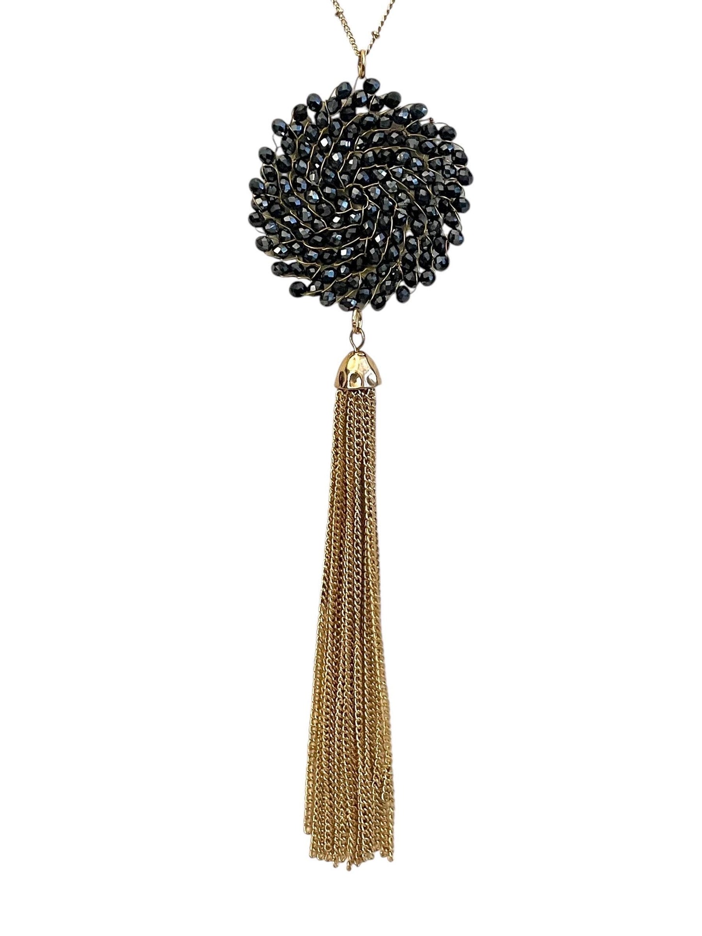 Vintage necklace featuring a black crystal wire linked circular pendant with long goldtone tassel