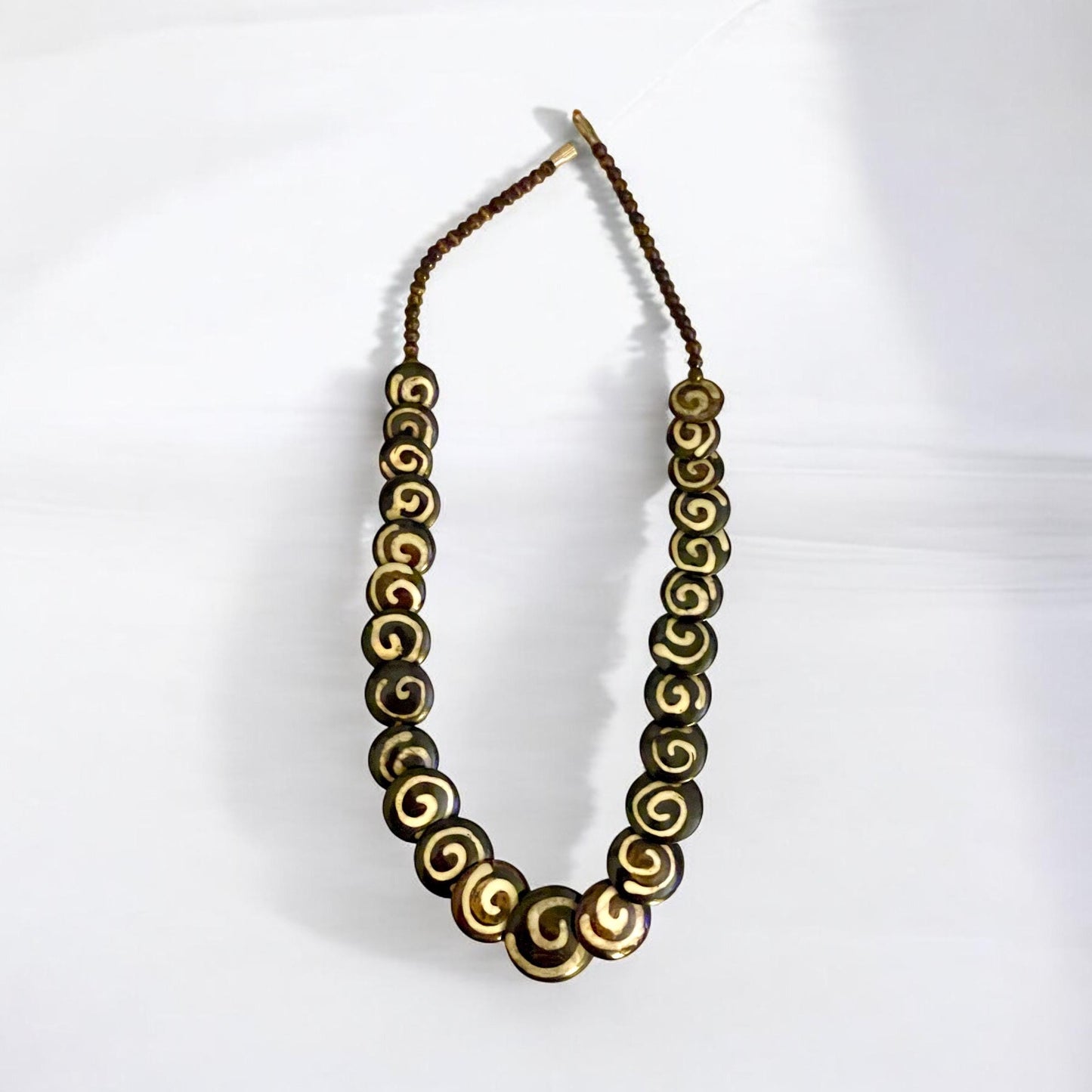 Tribal style vintage necklace - with beautiful swirled discs that are either bovine or wood?