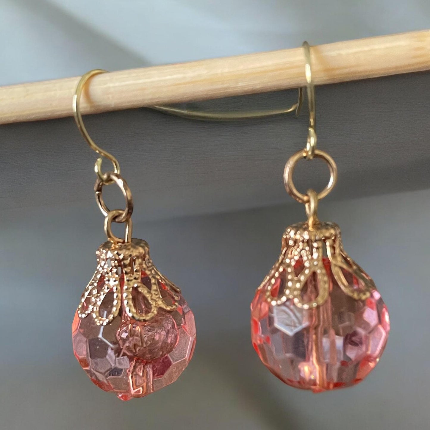 Pink faceted faux crystal earrings with goldstone filigree