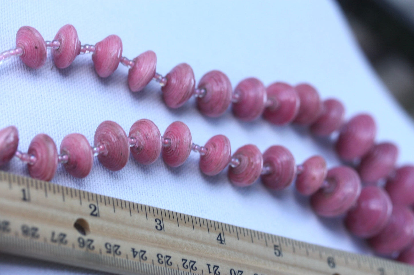 Long vintage various sized rolled paper light pink necklace