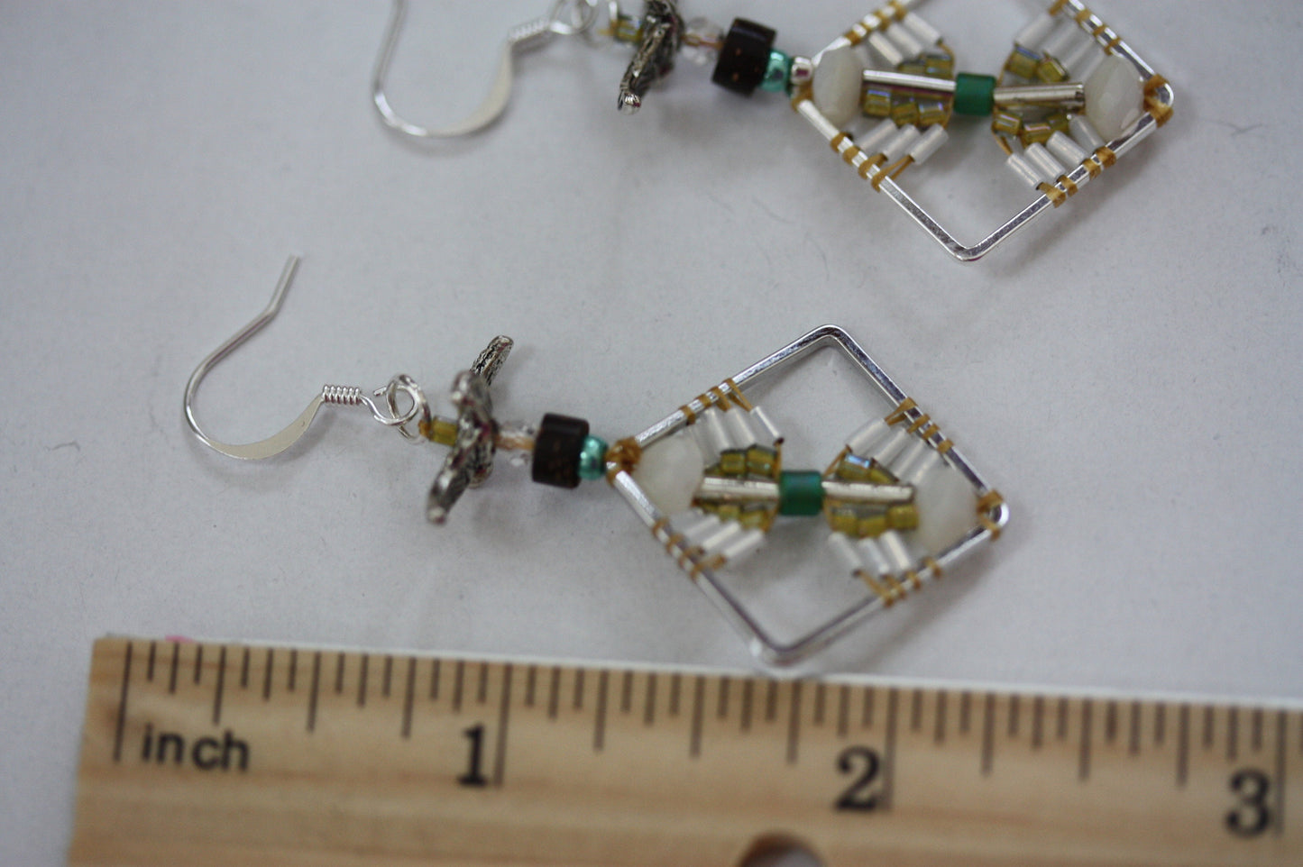 Birds taking flight - intricate beadwork seed bead dangle earrings on diamond-shaped base with flying bird embellishments