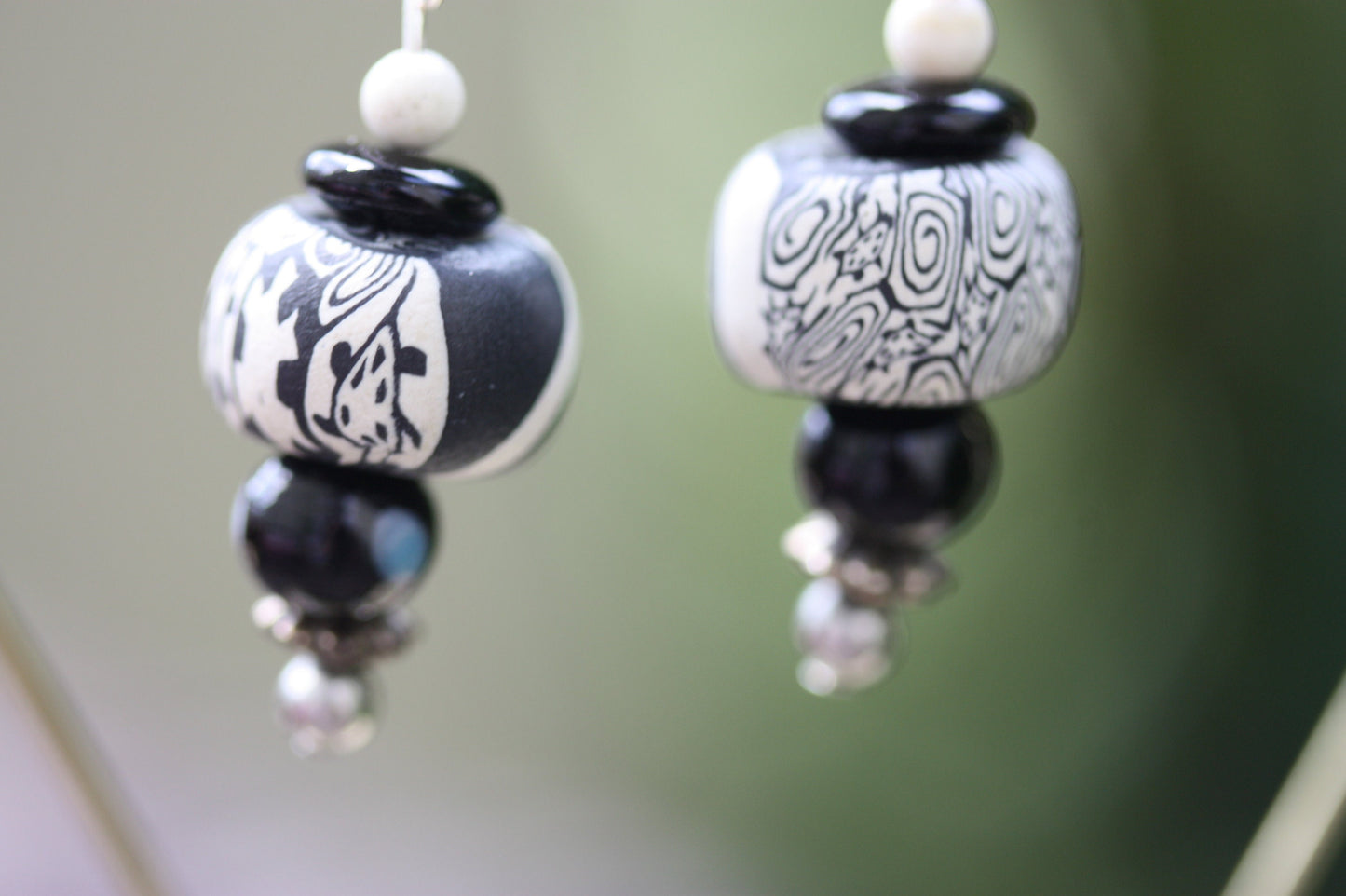 Black and white mixed media earrings made of upcycled polymer clay, combined with vintage black faux crystal, metal and glass spacer beads